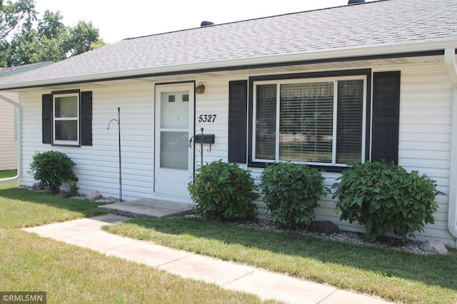 5327 53rd Ave N, Crystal, MN 55429 - view of front of house featuring roof with shingles, a front yard, and covered porch