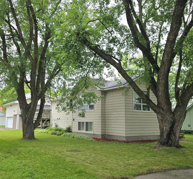 1218 2nd Ave E, International Falls, MN 56649 - view of home's exterior featuring a garage and a lawn