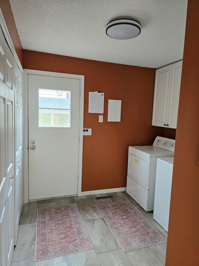 1218 2nd Ave E, International Falls, MN 56649 - washroom with washer and dryer, cabinet space, and a textured ceiling