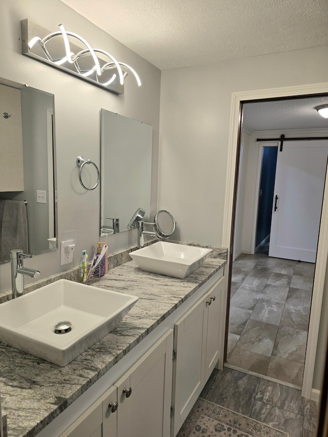 1218 2nd Ave E, International Falls, MN 56649 - full bath featuring marble look tile flooring, double vanity, and a textured ceiling
