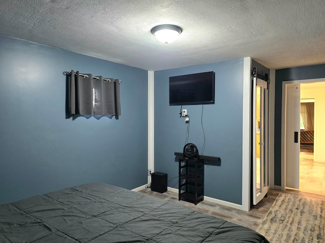 1218 2nd Ave E, International Falls, MN 56649 - bedroom featuring a textured ceiling and wood finished floors