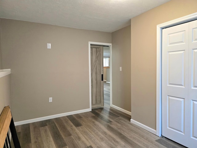 1218 2nd Ave E, International Falls, MN 56649 - spare room with dark wood-style floors and a textured ceiling
