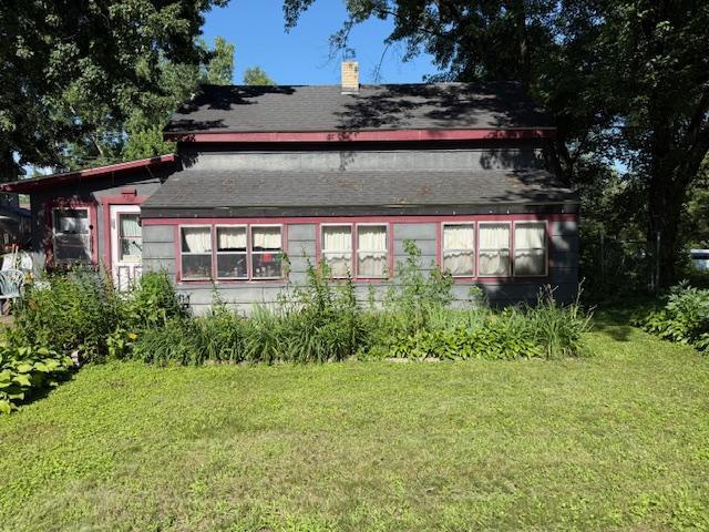 720 Main St, Clearwater, MN 55320 - back of house featuring a yard and a chimney