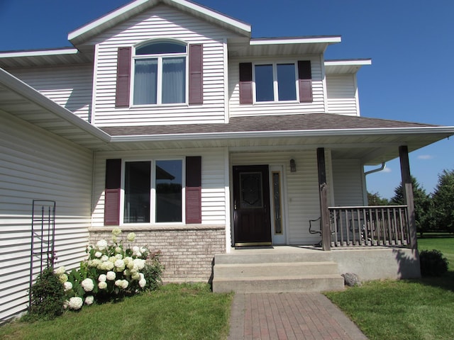 1575 Cornerstone Ln, Owatonna, MN 55060 - view of front of property featuring a porch, a shingled roof, and a front lawn