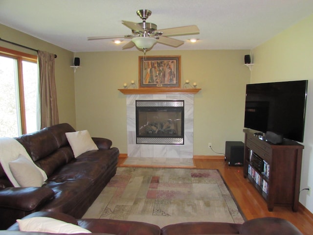 1575 Cornerstone Ln, Owatonna, MN 55060 - living area with wood finished floors, a tile fireplace, and a ceiling fan
