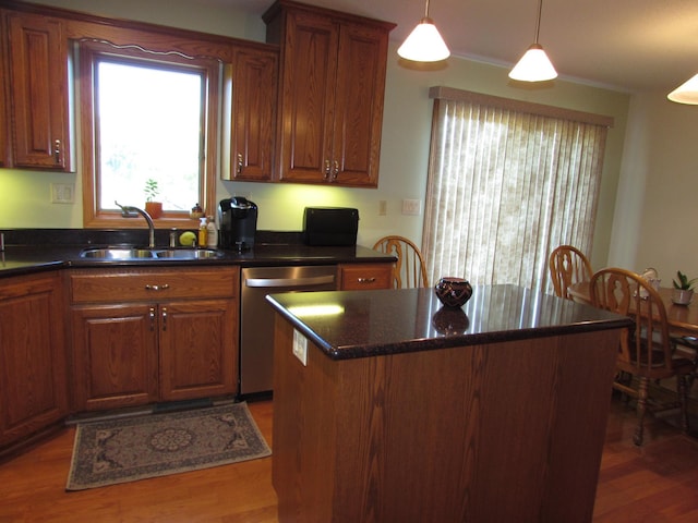 1575 Cornerstone Ln, Owatonna, MN 55060 - kitchen featuring dishwasher, wood finished floors, a center island, decorative light fixtures, and brown cabinetry