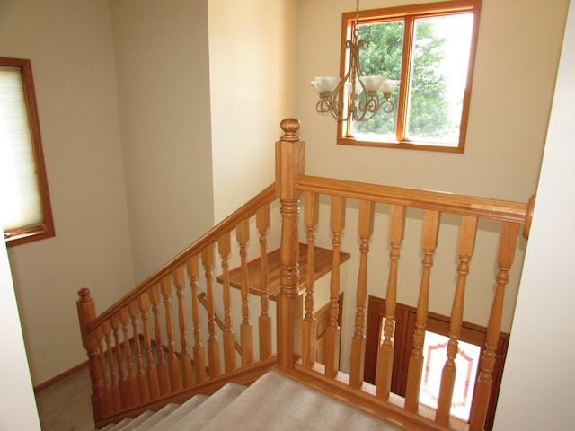 1575 Cornerstone Ln, Owatonna, MN 55060 - staircase featuring a chandelier