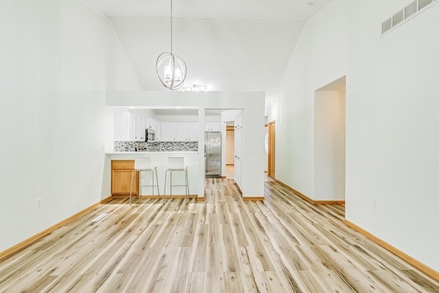 6873 Benton Way Unit 59, Inver Grove Heights, MN 55076 - living area featuring a chandelier, light wood-type flooring, and high vaulted ceiling