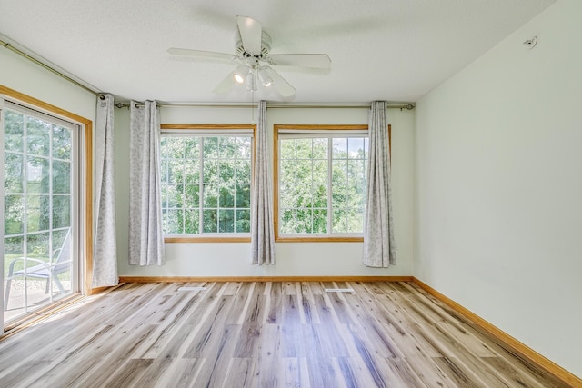 6873 Benton Way Unit 59, Inver Grove Heights, MN 55076 - unfurnished room with healthy amount of natural light, wood finished floors, and ceiling fan