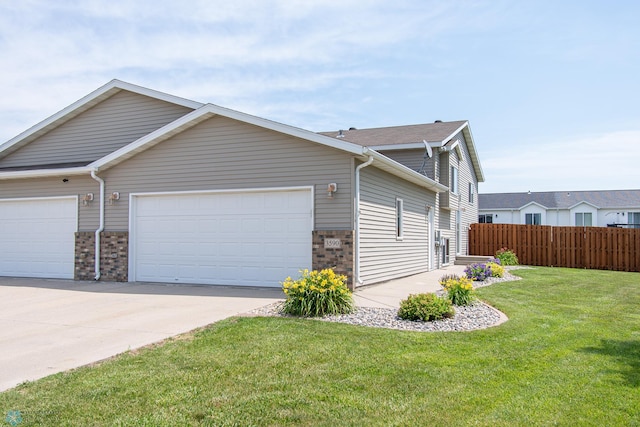 3590 Fillmore St S, Fargo, ND 58104 - view of side of property featuring driveway, an attached garage, and brick siding