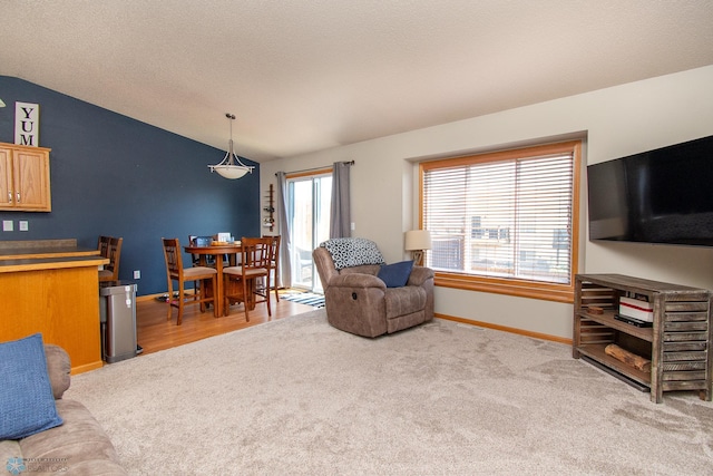 3590 Fillmore St S, Fargo, ND 58104 - living area featuring lofted ceiling and carpet