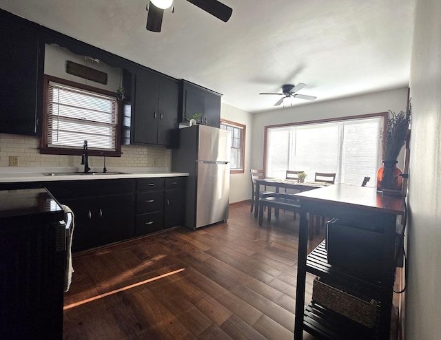 3709 Quail Ave N, Robbinsdale, MN 55422 - kitchen with freestanding refrigerator, ceiling fan, and dark cabinets