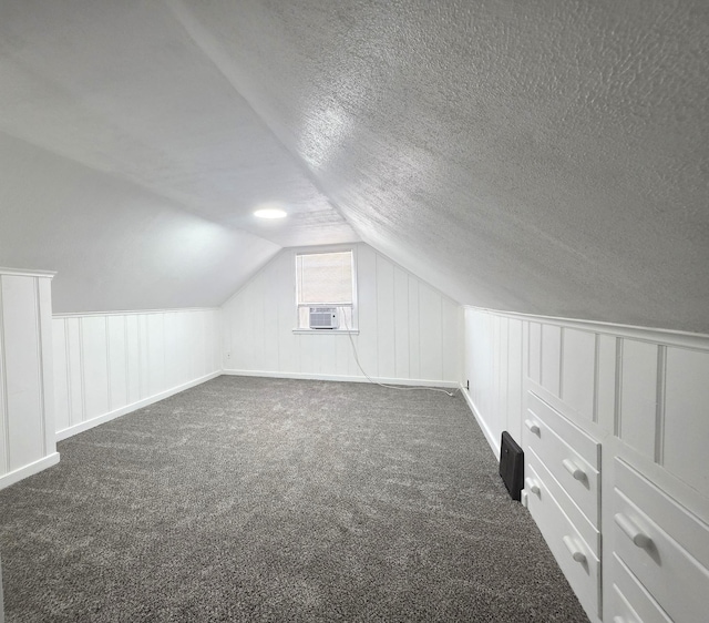 3709 Quail Ave N, Robbinsdale, MN 55422 - bonus room featuring a decorative wall, dark colored carpet, lofted ceiling, a textured ceiling, and cooling unit