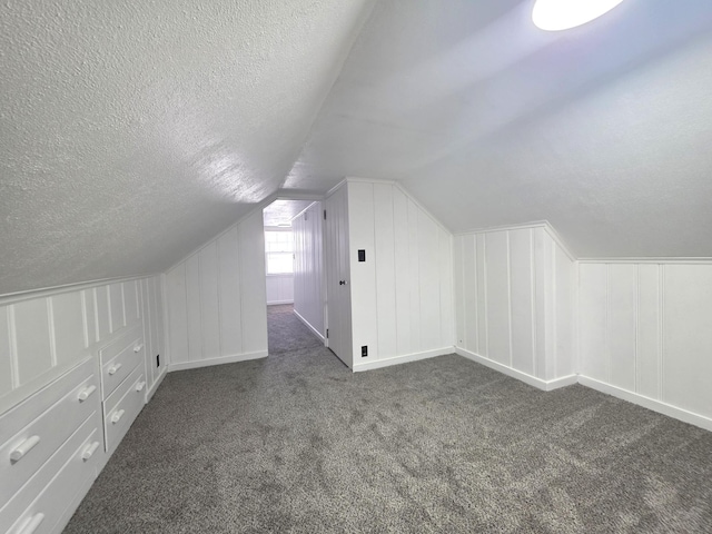 3709 Quail Ave N, Robbinsdale, MN 55422 - additional living space with a decorative wall, carpet, a textured ceiling, and lofted ceiling