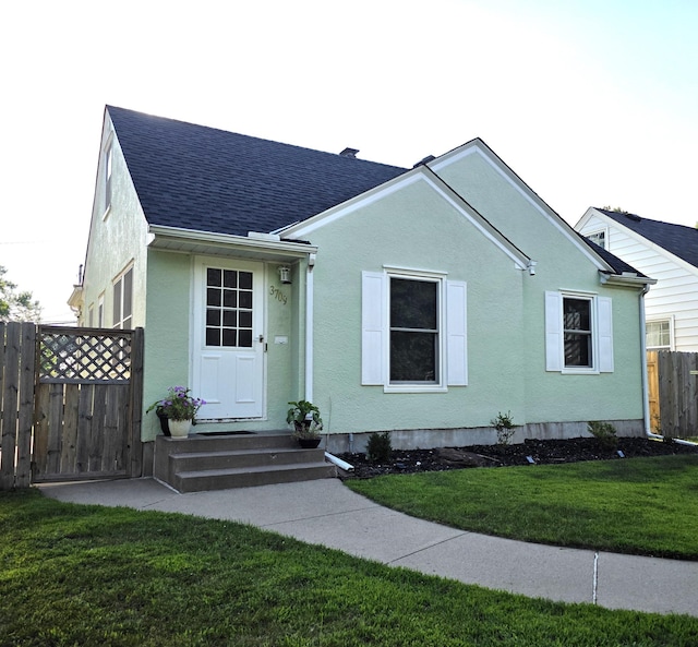 3709 Quail Ave N, Robbinsdale, MN 55422 - view of front facade featuring roof with shingles and stucco siding