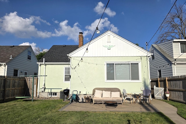 3709 Quail Ave N, Robbinsdale, MN 55422 - back of house featuring a fenced backyard, a chimney, a patio, stucco siding, and roof with shingles