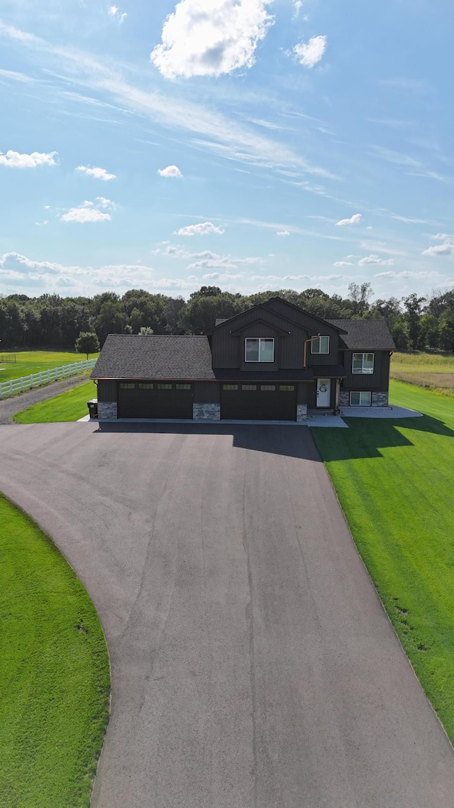 23900 Taurus St, Linwood Twp, MN 55079 - view of front of home with driveway, a front lawn, and a garage