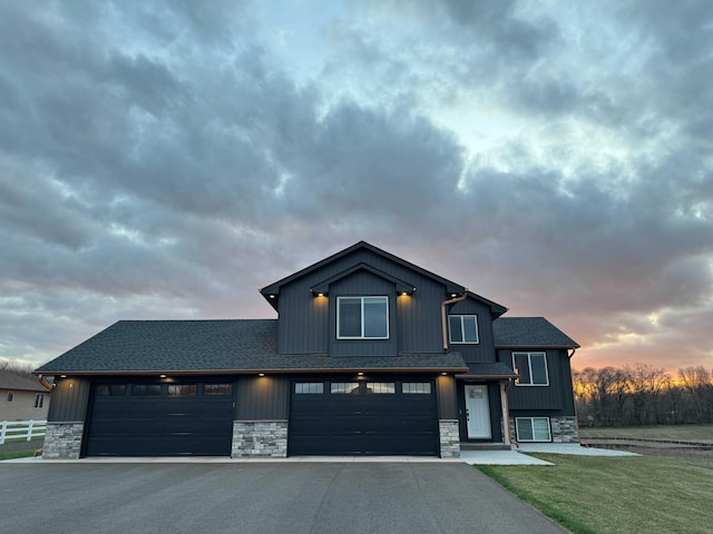 23900 Taurus St, Linwood Twp, MN 55079 - view of front of property with asphalt driveway, stone siding, roof with shingles, and board and batten siding