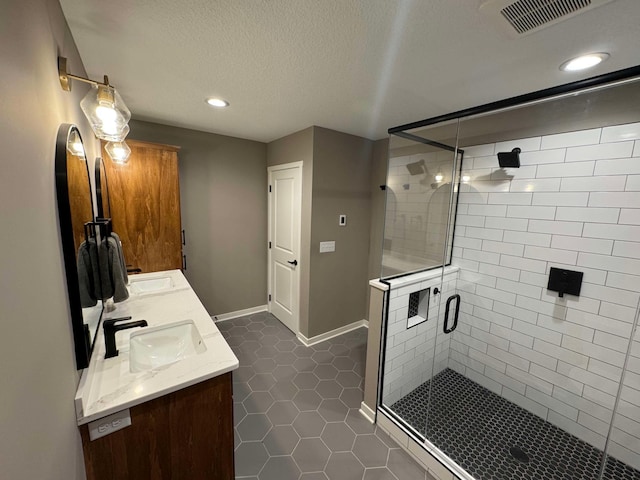 23900 Taurus St, Linwood Twp, MN 55079 - bathroom featuring double vanity, a shower stall, recessed lighting, tile patterned floors, and a textured ceiling