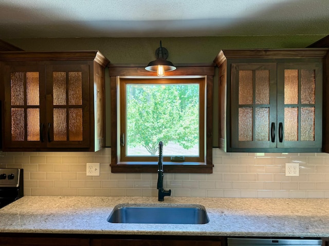90760 US Highway 71, Christiania Twp, MN 56101 - kitchen with decorative backsplash, glass insert cabinets, electric range, and hanging light fixtures