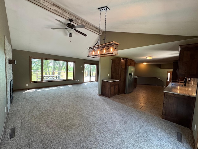 90760 US Highway 71, Christiania Twp, MN 56101 - kitchen with open floor plan, carpet, stainless steel fridge with ice dispenser, and ceiling fan
