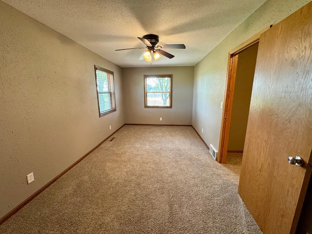 90760 US Highway 71, Christiania Twp, MN 56101 - carpeted spare room with a textured wall, ceiling fan, and a textured ceiling