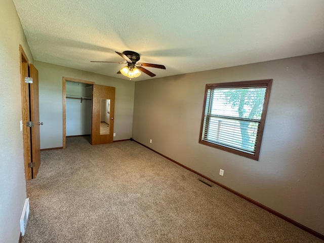 90760 US Highway 71, Christiania Twp, MN 56101 - unfurnished bedroom featuring a closet, a textured ceiling, carpet floors, and ceiling fan