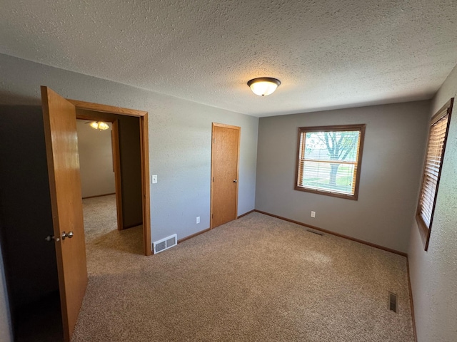 90760 US Highway 71, Christiania Twp, MN 56101 - unfurnished bedroom with carpet, a textured ceiling, and a closet