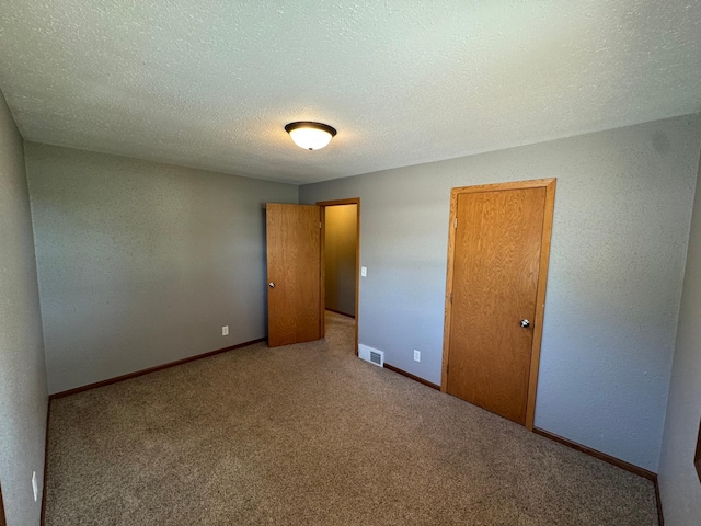 90760 US Highway 71, Christiania Twp, MN 56101 - unfurnished bedroom with a textured ceiling and carpet