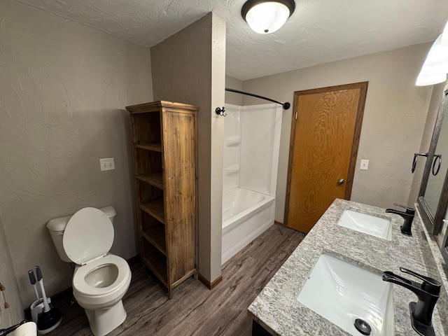 90760 US Highway 71, Christiania Twp, MN 56101 - bathroom featuring wood finished floors, double vanity, bathtub / shower combination, and a textured ceiling
