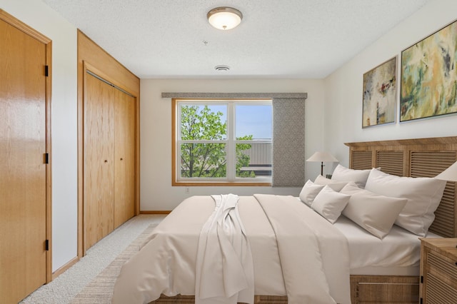 2231 Penn Pl Unit 224, North Saint Paul, MN 55109 - bedroom with a textured ceiling and light colored carpet