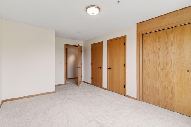 2231 Penn Pl Unit 224, North Saint Paul, MN 55109 - unfurnished bedroom featuring carpet and multiple closets