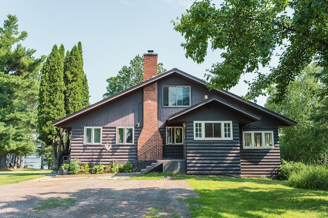 5607 Skogvei Rd, Duluth, MN 55803 - chalet / cabin featuring a front lawn, a chimney, and faux log siding