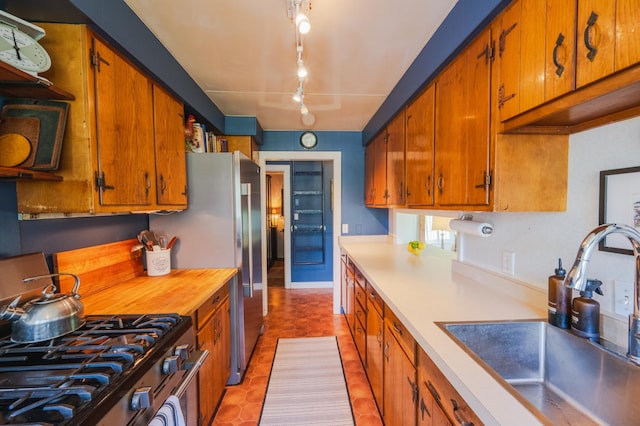 5607 Skogvei Rd, Duluth, MN 55803 - kitchen with stainless steel appliances, brown cabinetry, and light countertops