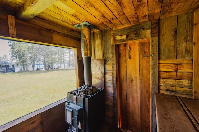 5607 Skogvei Rd, Duluth, MN 55803 - miscellaneous room with wooden ceiling, wood walls, a wood stove, and hardwood / wood-style floors