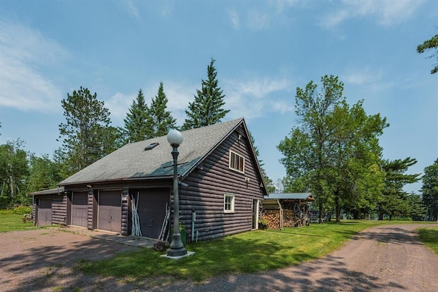 5607 Skogvei Rd, Duluth, MN 55803 - view of home's exterior featuring a garage, a lawn, faux log siding, and roof with shingles