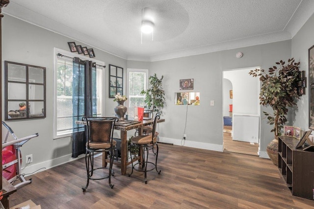 4111 Bryant Ave N, Minneapolis, MN 55412 - dining space featuring arched walkways, a textured ceiling, ornamental molding, wood finished floors, and ceiling fan