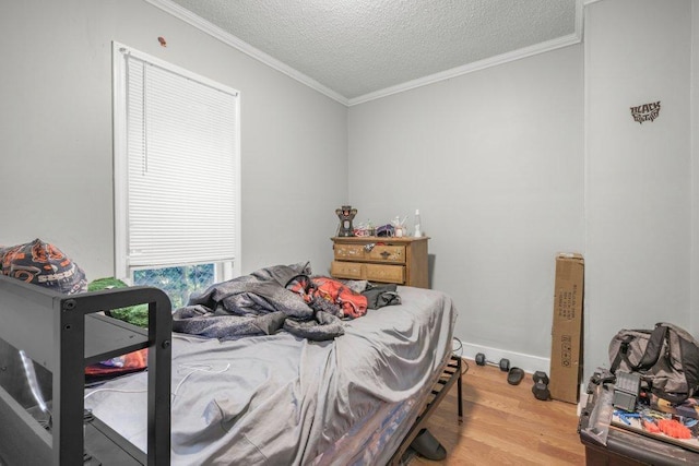 4111 Bryant Ave N, Minneapolis, MN 55412 - bedroom with wood finished floors, ornamental molding, and a textured ceiling