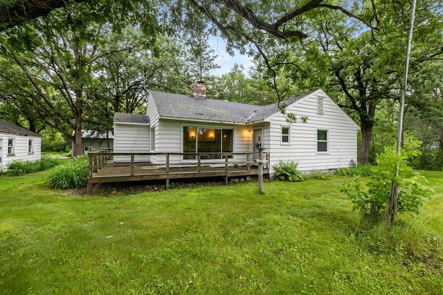 13425 Pillager Dam Rd SW, Sylvan Twp, MN 56473 - back of property featuring a wooden deck, a lawn, a chimney, and a shingled roof