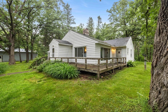 13425 Pillager Dam Rd SW, Sylvan Twp, MN 56473 - back of house featuring a wooden deck, a yard, a chimney, and a shingled roof
