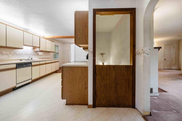 13425 Pillager Dam Rd SW, Sylvan Twp, MN 56473 - kitchen with light countertops, white appliances, arched walkways, and cream cabinetry