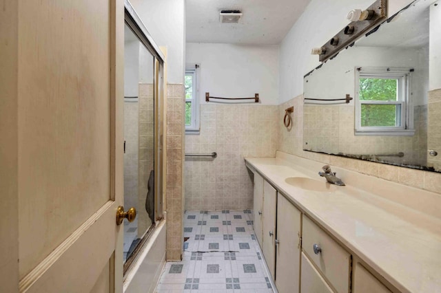 13425 Pillager Dam Rd SW, Sylvan Twp, MN 56473 - full bathroom featuring vanity, tile walls, enclosed tub / shower combo, and a wainscoted wall