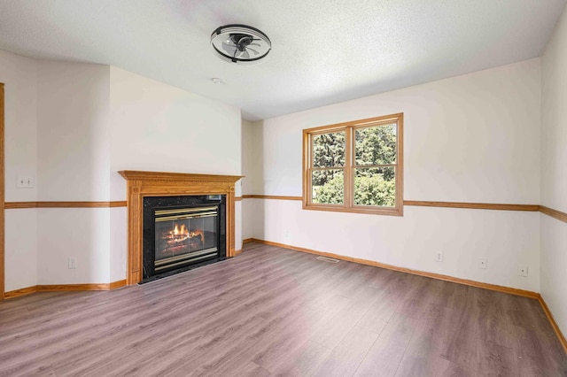 51800 500th St, Menahga, MN 56464 - unfurnished living room featuring wood finished floors and a glass covered fireplace