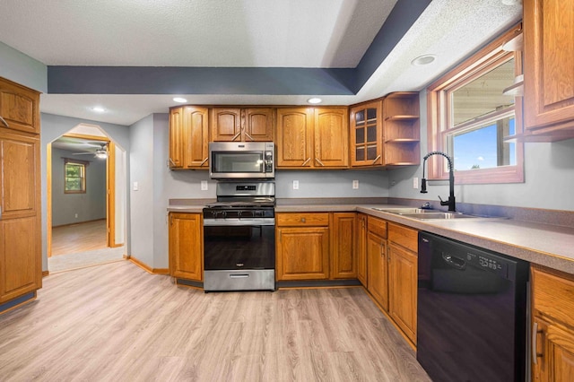 51800 500th St, Menahga, MN 56464 - kitchen with stainless steel appliances, brown cabinets, light wood-style floors, and recessed lighting