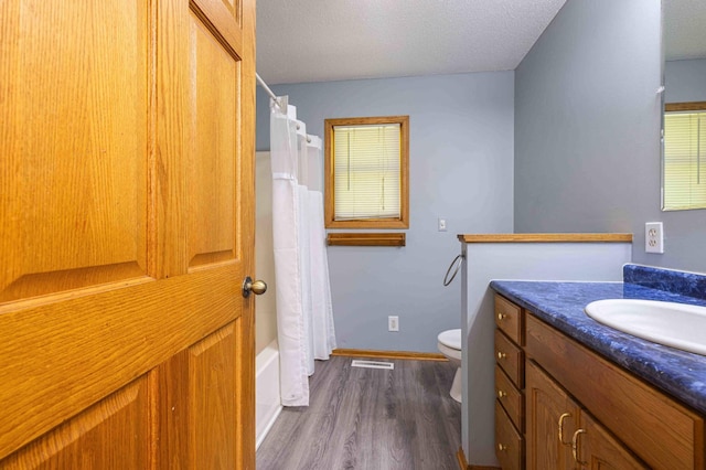 51800 500th St, Menahga, MN 56464 - bathroom with vanity, wood finished floors, shower / tub combo, and a textured ceiling