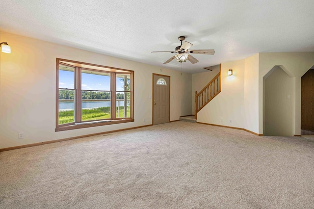 51800 500th St, Menahga, MN 56464 - unfurnished living room featuring light carpet, ceiling fan, a water view, and stairway