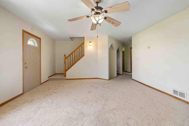 51800 500th St, Menahga, MN 56464 - unfurnished living room featuring stairs, a ceiling fan, and carpet