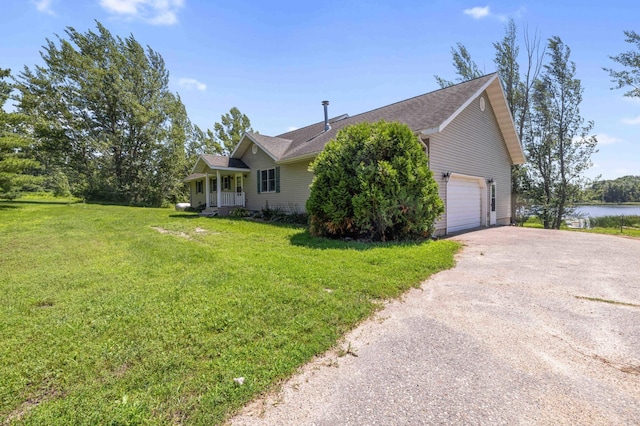 51800 500th St, Menahga, MN 56464 - view of front facade featuring asphalt driveway, a front yard, a garage, a water view, and roof with shingles