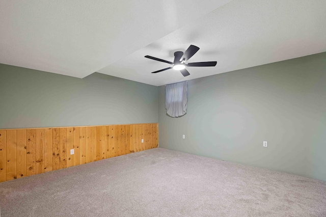 51800 500th St, Menahga, MN 56464 - spare room with carpet flooring, ceiling fan, wooden walls, and a wainscoted wall