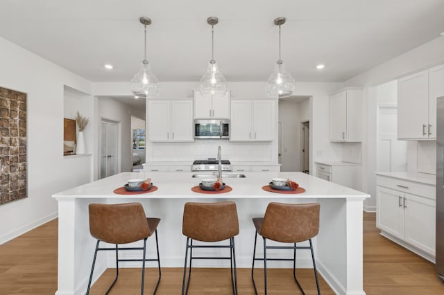 15188 Palm St NW, Andover, MN 55304 - kitchen featuring backsplash, white cabinetry, light wood-style flooring, light countertops, and recessed lighting